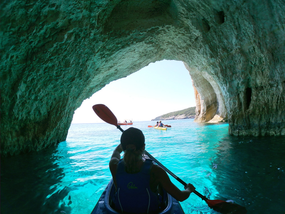 sea kayak entering under blue cave - Zakynthos
